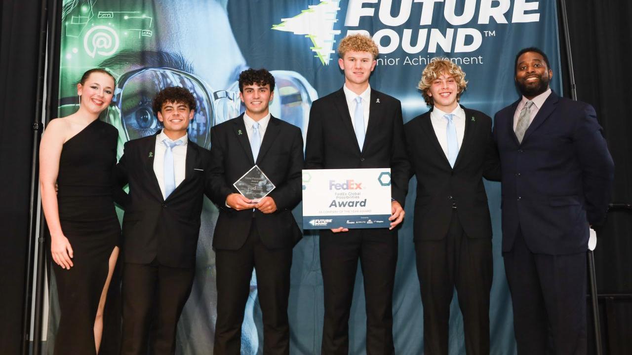 6 people on stage accepting an award