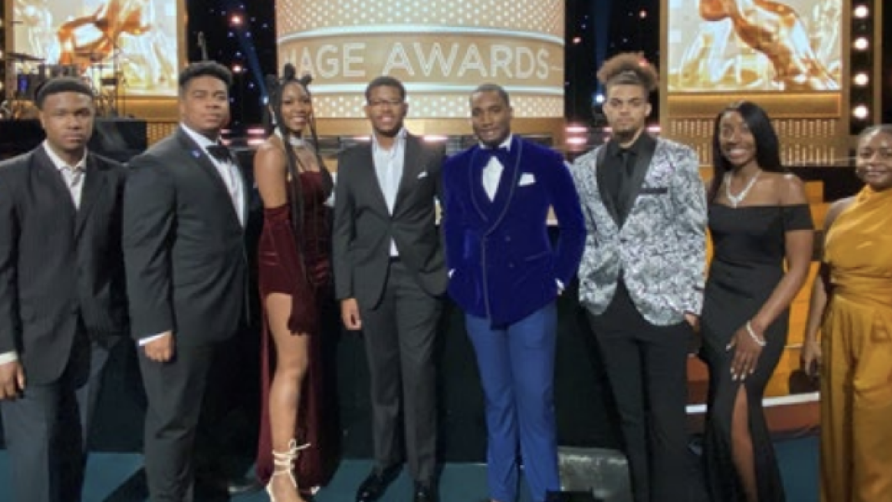 A group of people in formal clothing at a award show