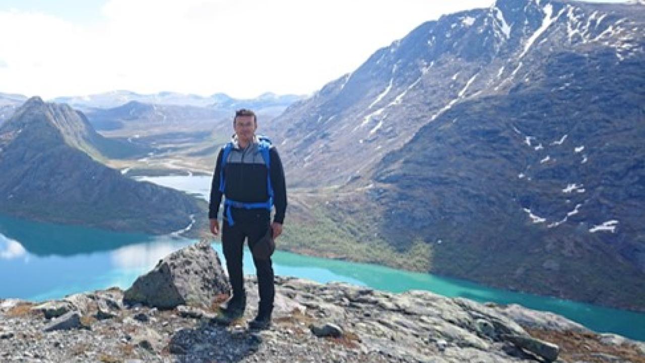 Dr. Ayush Mishra stood on a mountain 
