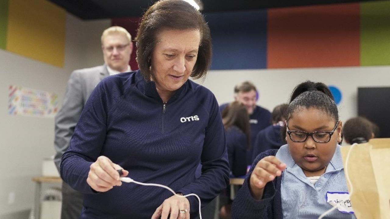Otis Chair, Chief Executive Officer and President, Judy Marks builds robot with Boys and Girls Club member