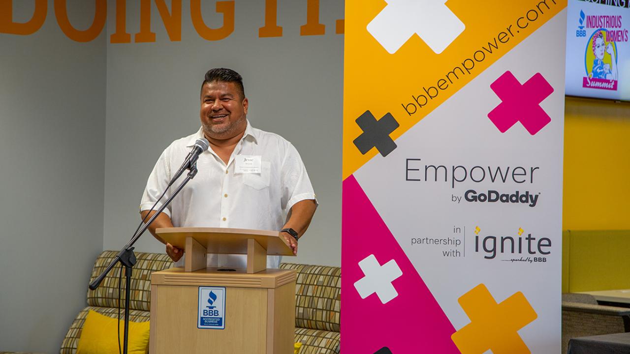 person speaking at a podium 