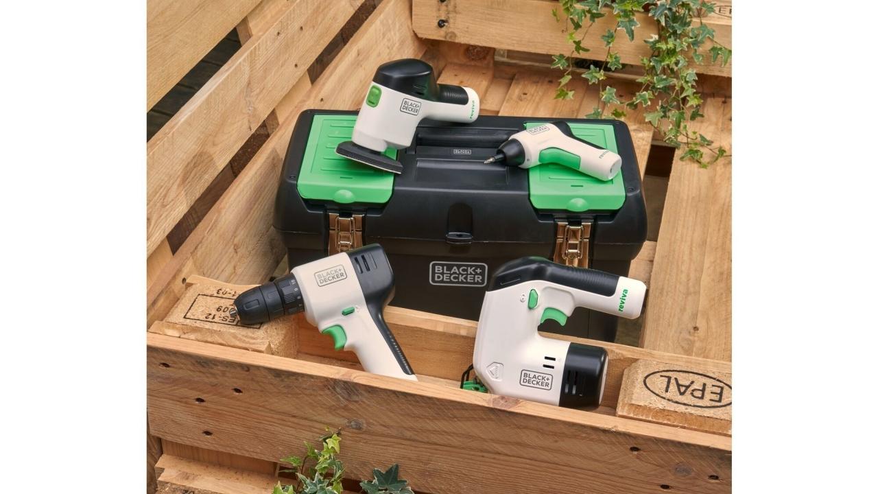 Wooden pallets stacked, white, black and green colored tools laying on top along with a carrying case.