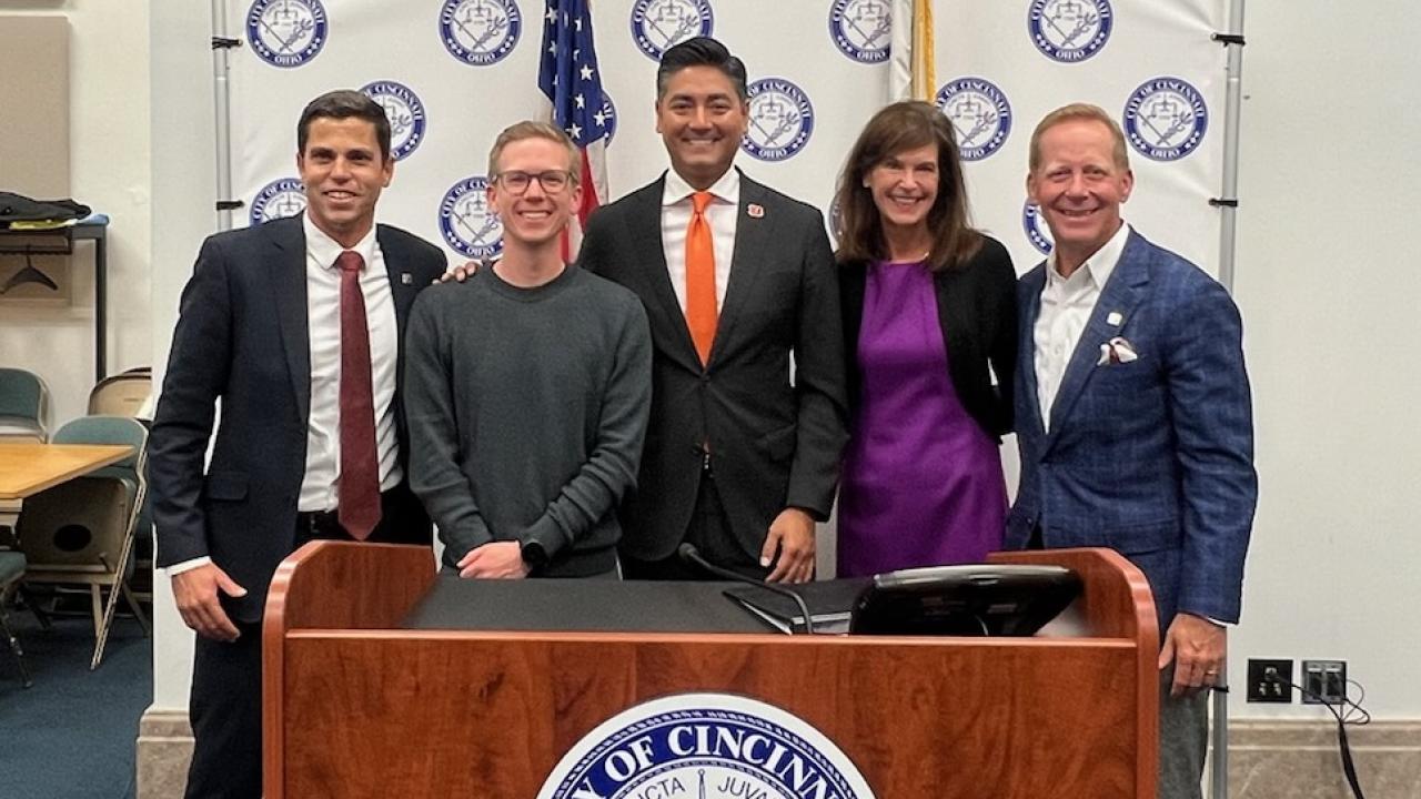 5 people pose for a photo