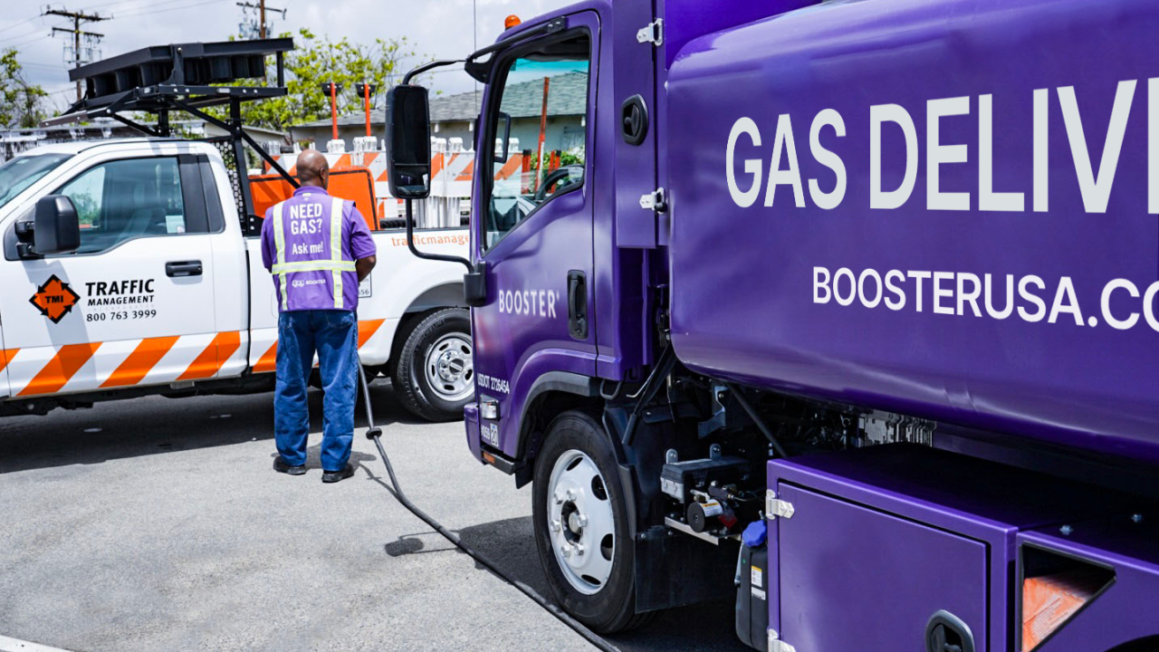 A Booster service professional fuels a Traffic Management truck. 