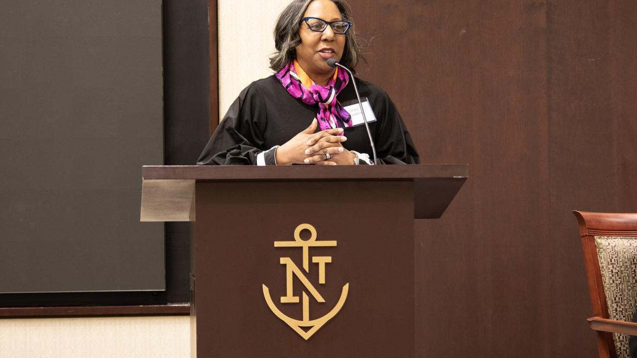 A speaker at a podium