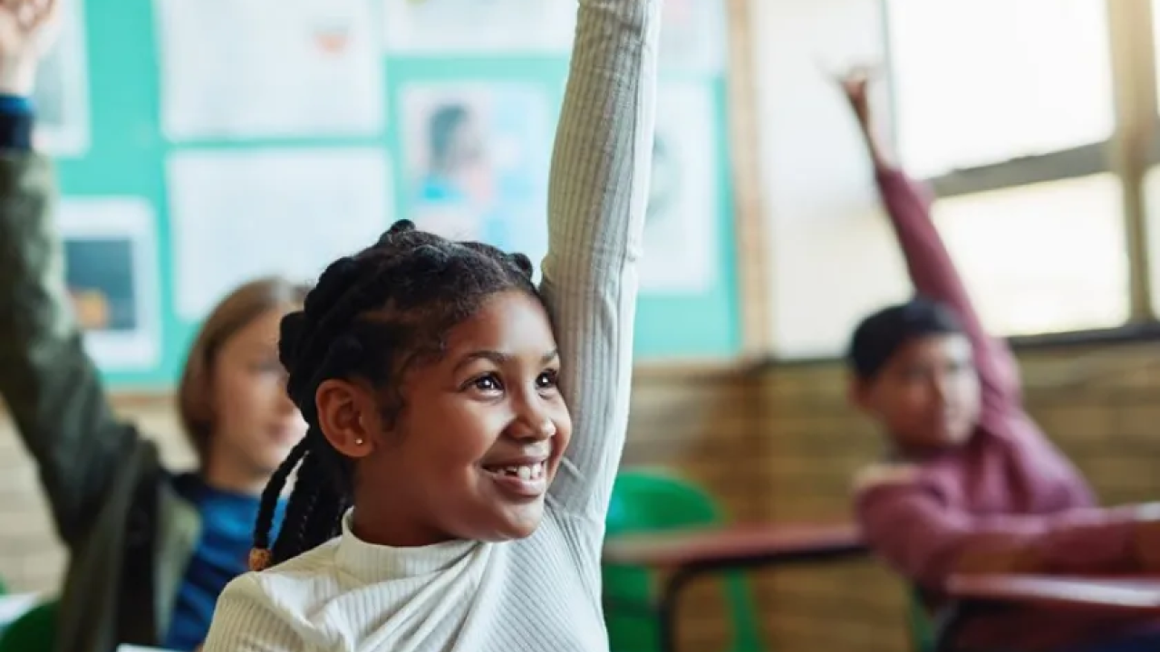 child raising her hand