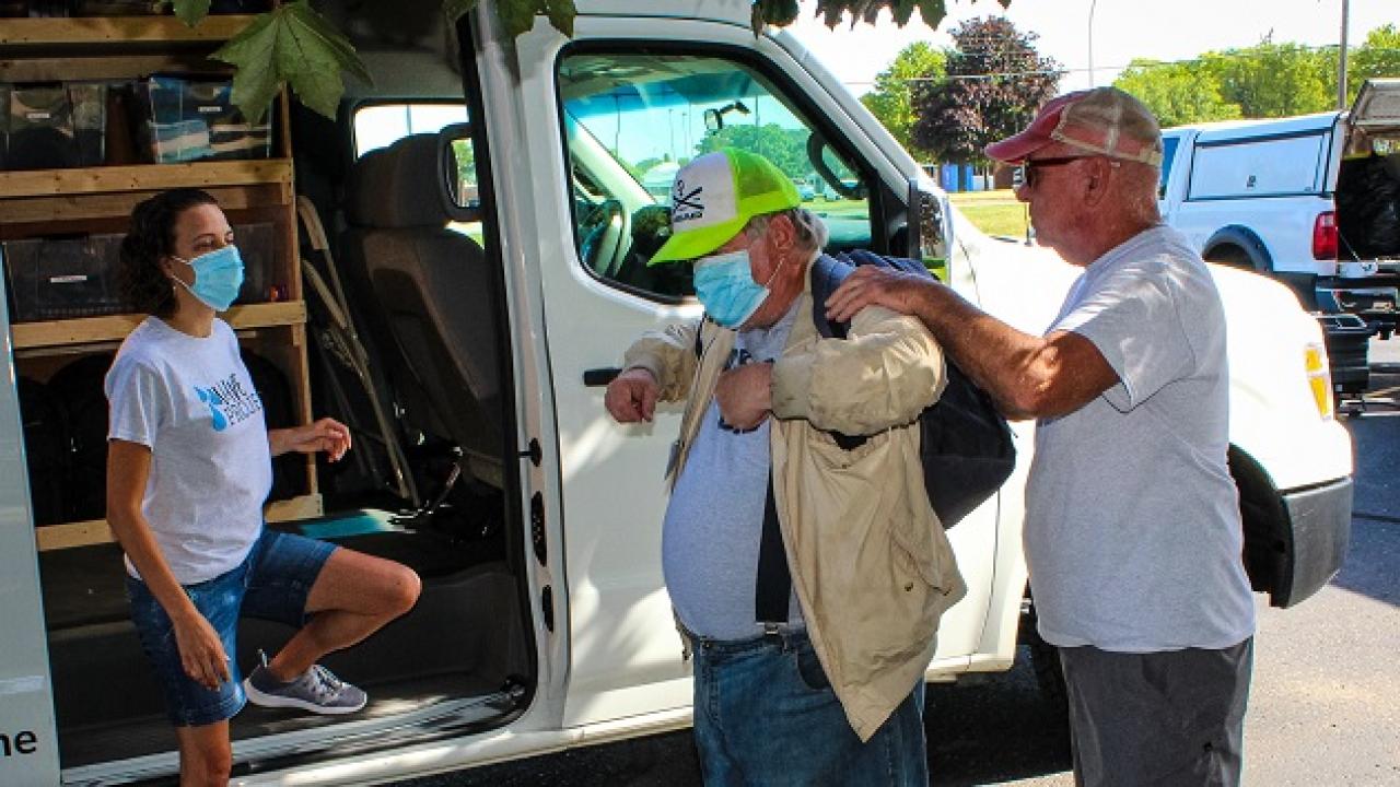 People trying on clothing supplied by the WAVE project