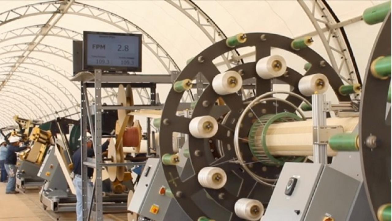 Workers produce the company's innovative liner product at a Smartpipe mobile factory.