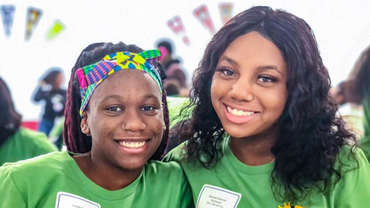 Two students smiling