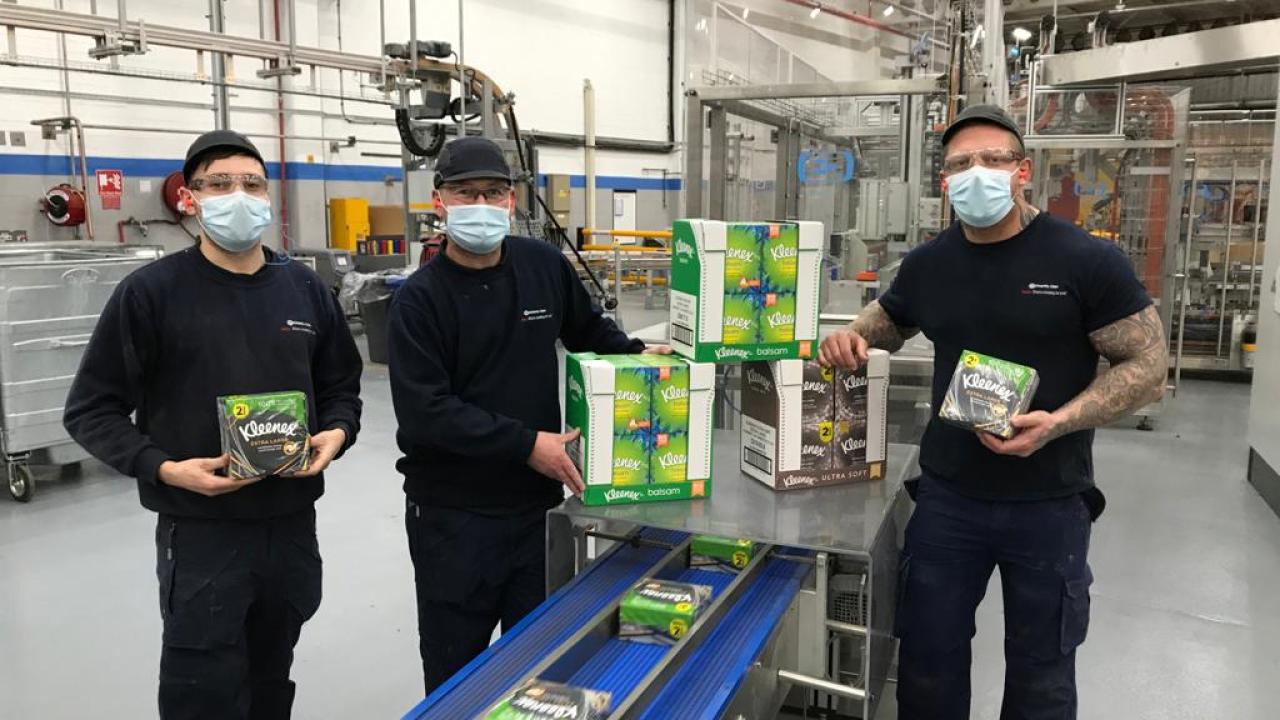 Several of Kimberly-Clark's employees hold Kleenex® products at the company's Barrow manufacturing facility in the UK.