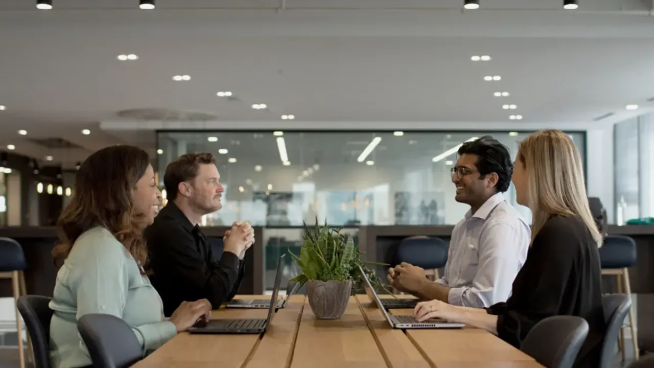 People sitting together and smiling at a conference table