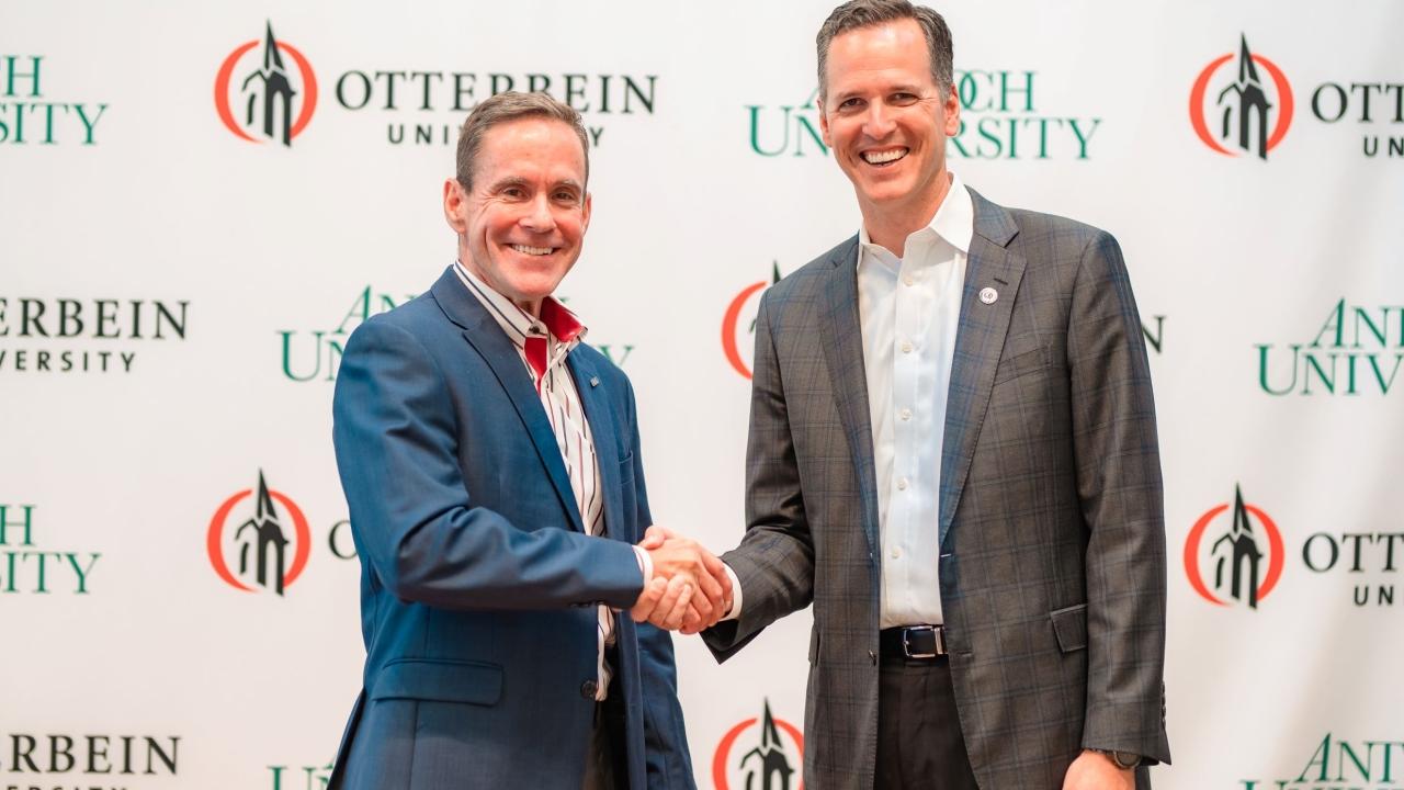 William R. Groves, J.D., chancellor of Antioch University, and John Comerford, Ph.D., president of Otterbein University, shake hands after the historic announcement of their institutions' intention to affiliate with each other to create a unique, national, nonprofit university system focused on educating students both for careers and to prepare students to advance social justice, democracy, and the common good.
