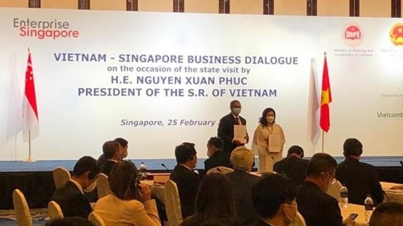 Presentation in front of audience with two people standing on stage