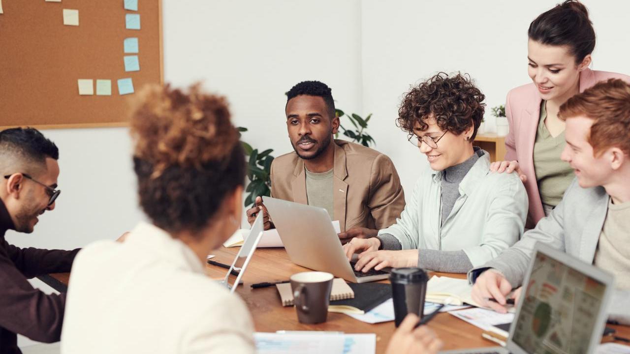A diverse group of people talking at a large table.