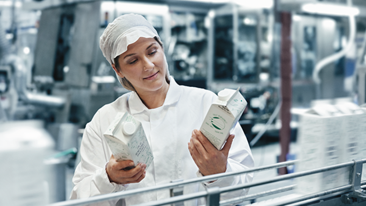 woman looking at milk container