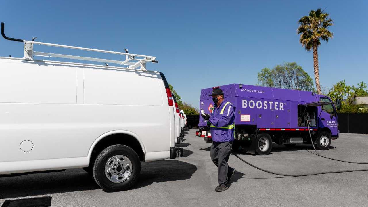 Booster tanker fueling a white van
