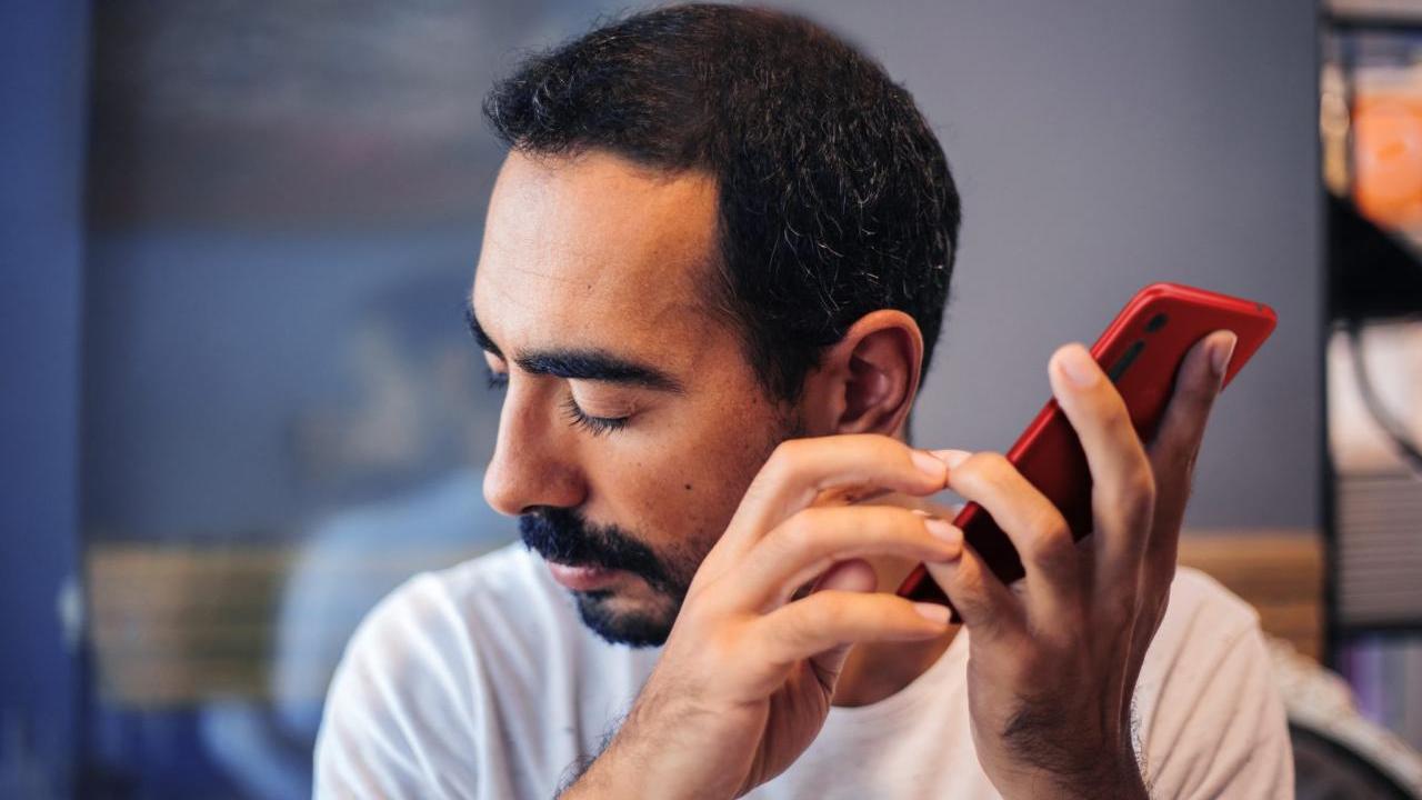 person listening to smart phone
