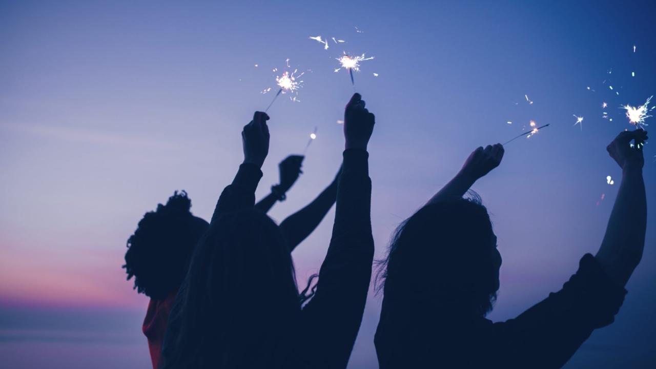 People with sparklers at night