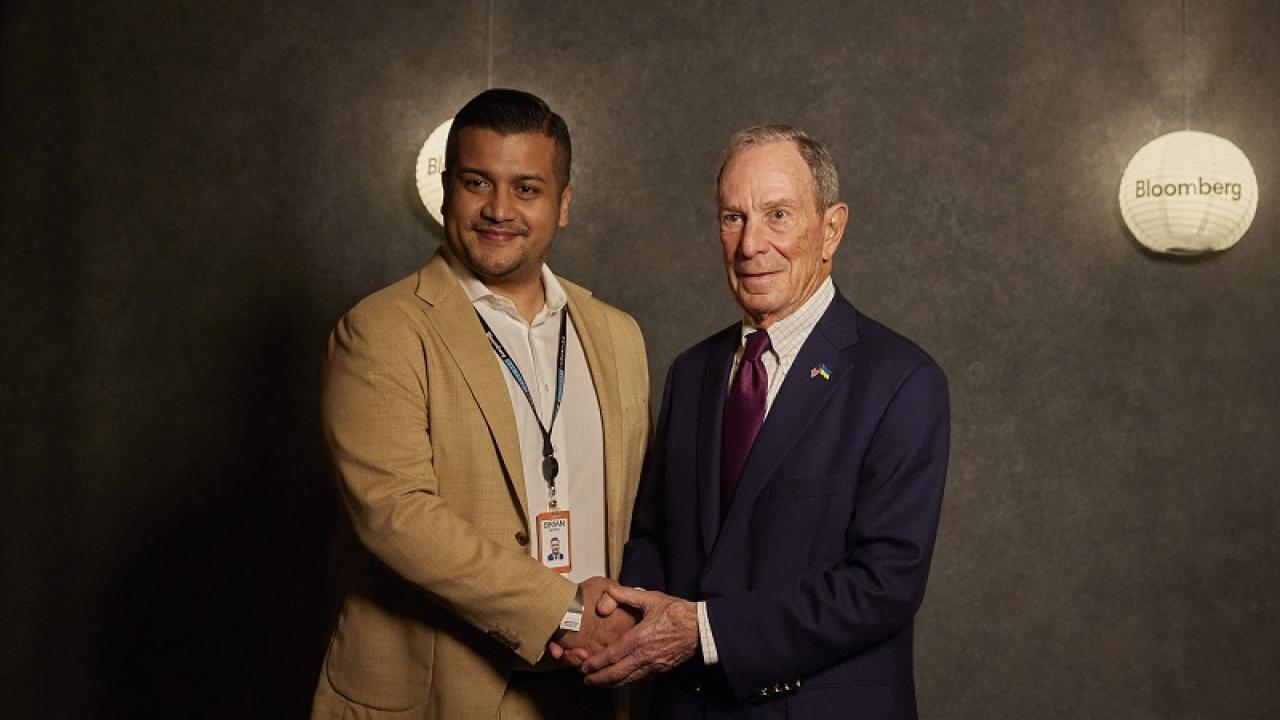 Two people shaking hands for a photo