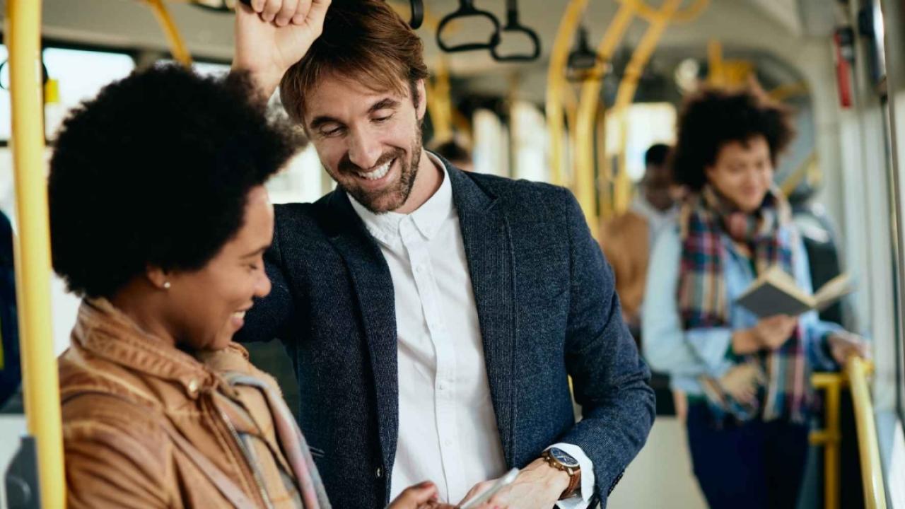 people stand while riding on a bus