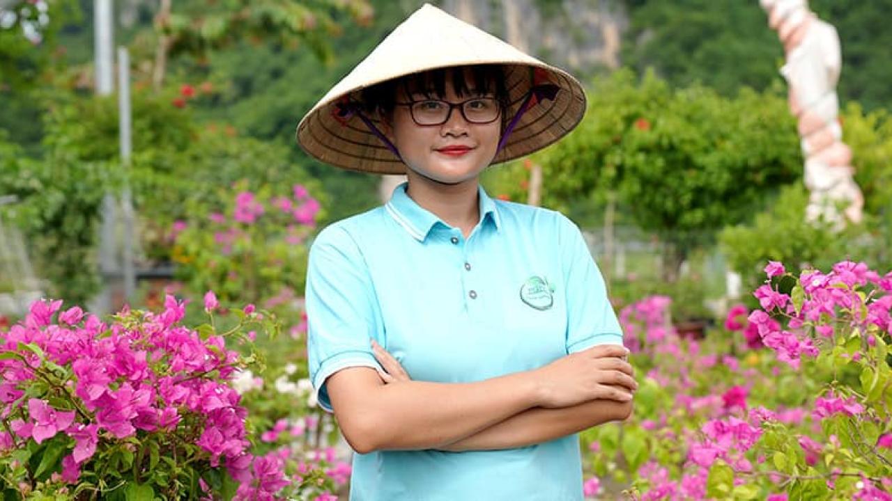 Pham Phoung Thao outside, surrounded by flowers
