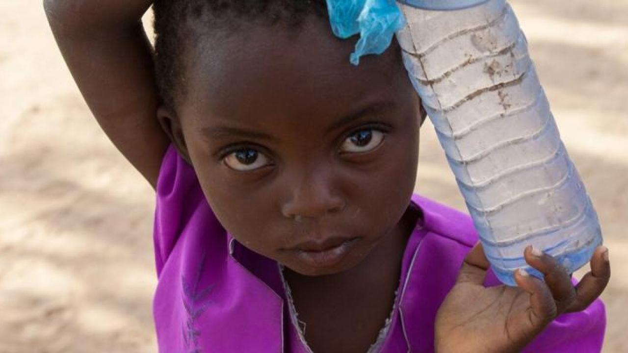 A child holding a bottle of water