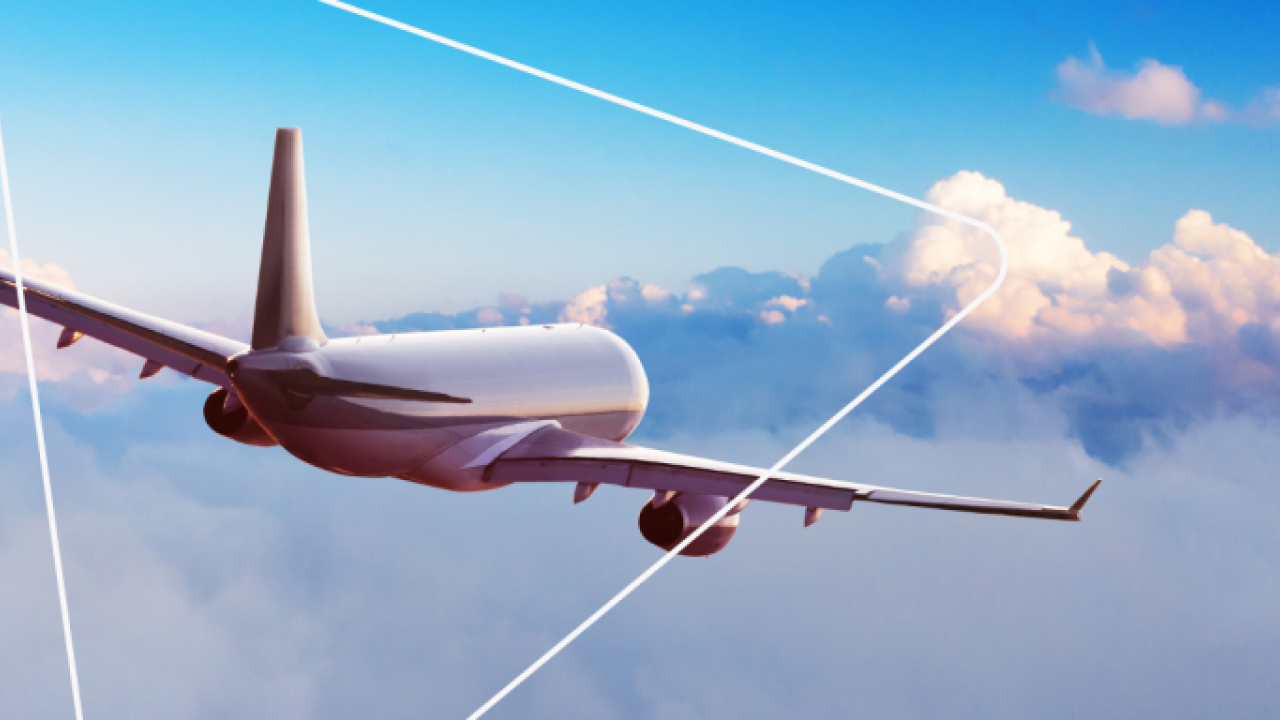 tail of an airplane flying above clouds, superimposed with a thin, white triangle