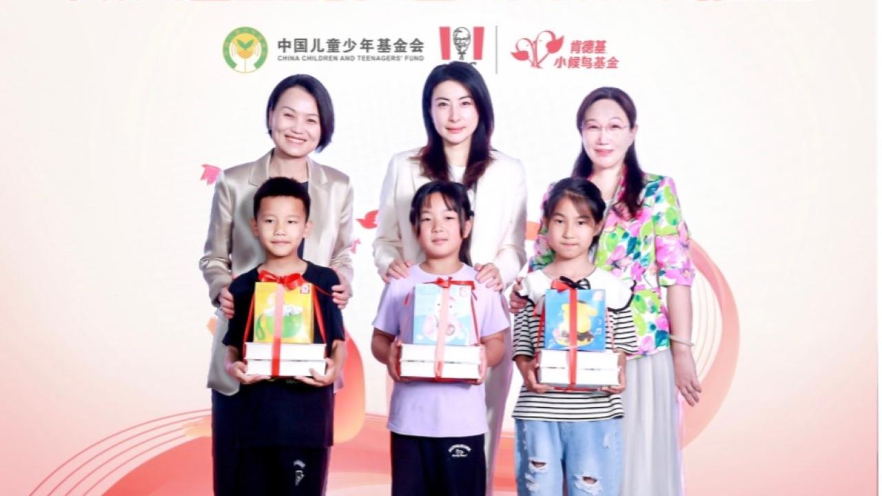 Three children standing with gifts in front of three adults