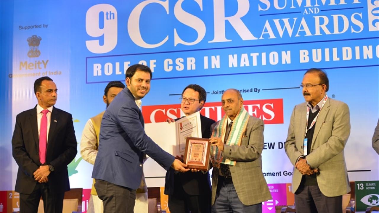 People receiving award on stage