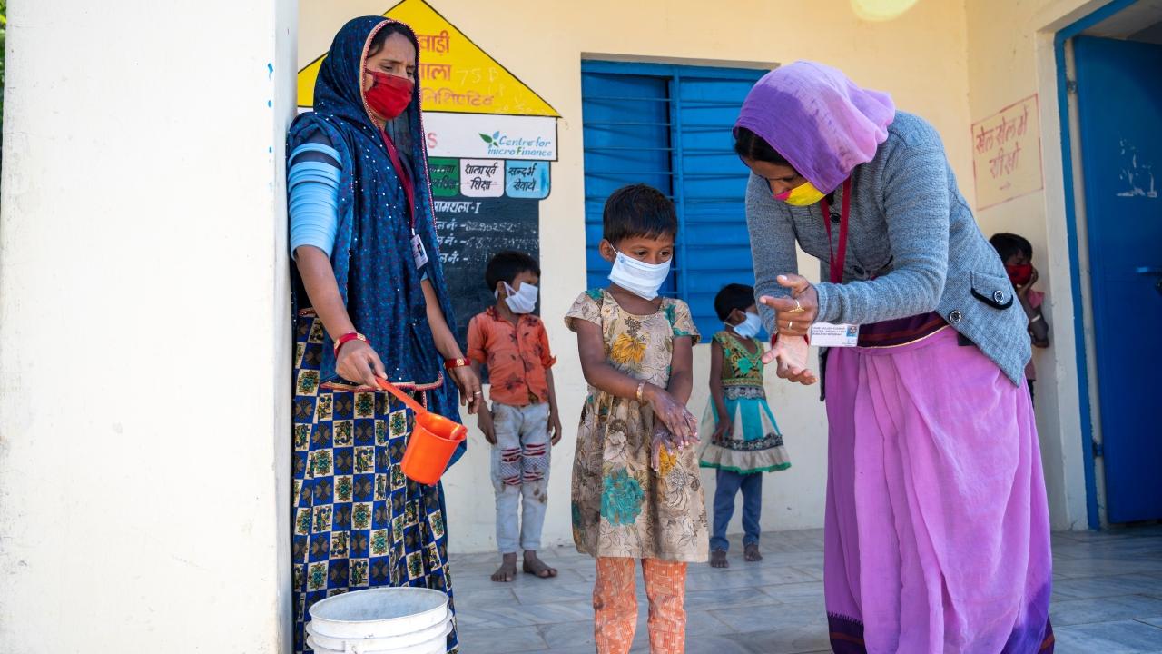 AWW and Sahaika demonstrate hand wash techniques to kids. Village Amthala, Abu Road, Rajasthan