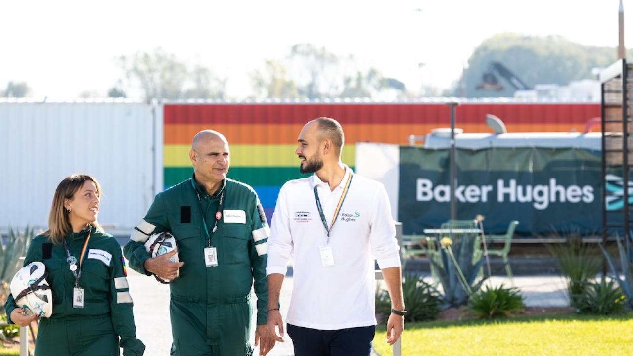 Three employees walking together outside