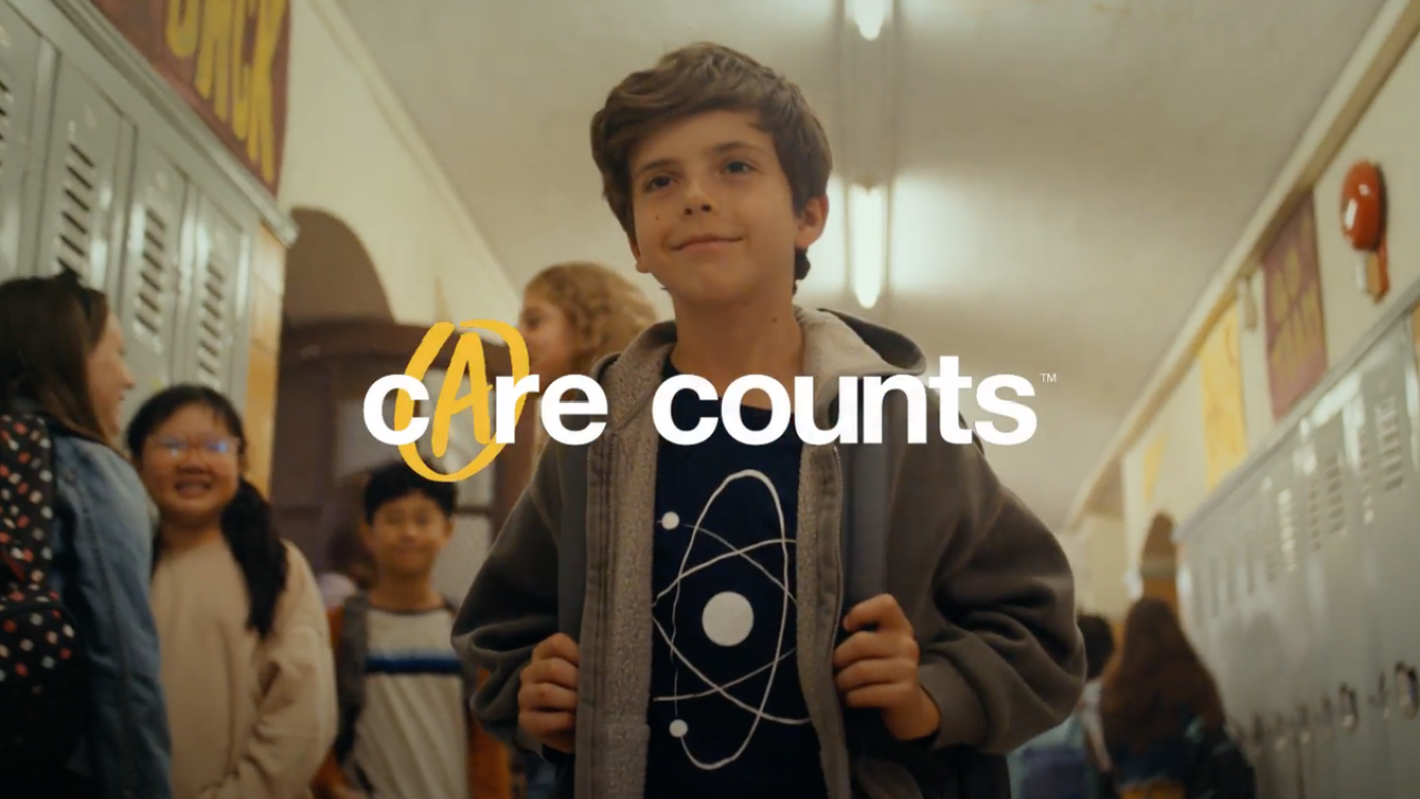 A photo of a child walking through a school corridor with the text 'Care Counts™'