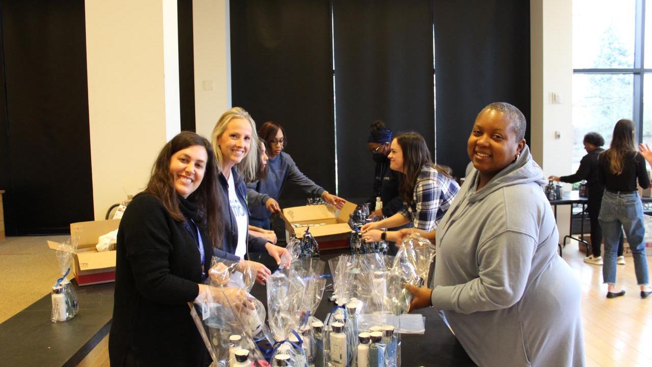 Bath & Body Works associates gather to support women transitioning from the program and into new homes by creating Bath & Body 