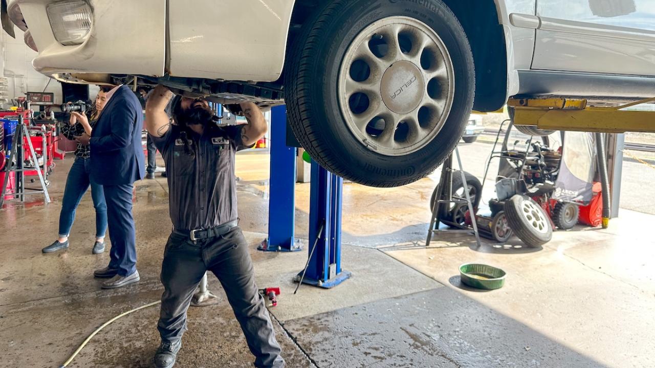 person working on a car up on a lift