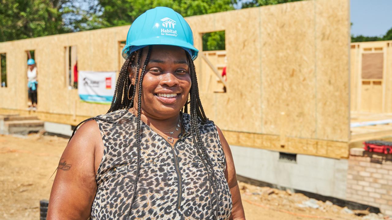 Habitat for Humanity homeowner Shaquawanda stands in front of the build site of her future home