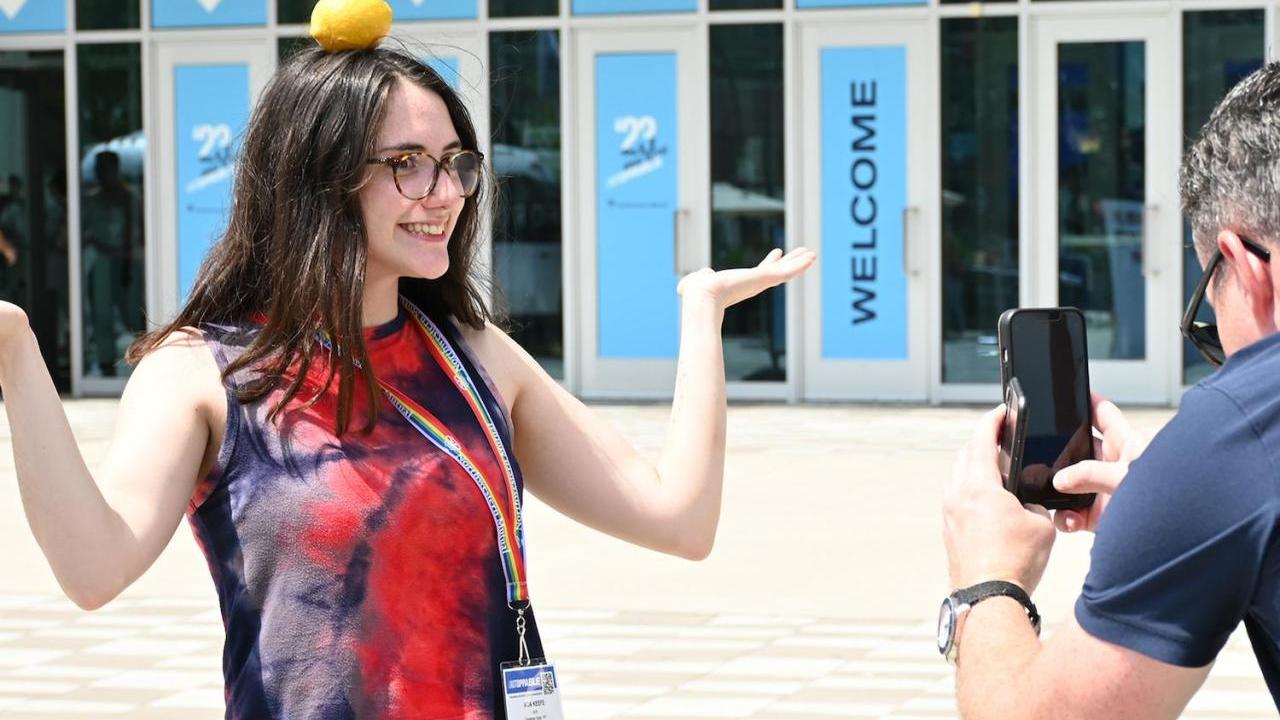 Person having photo taken with lemon on their head