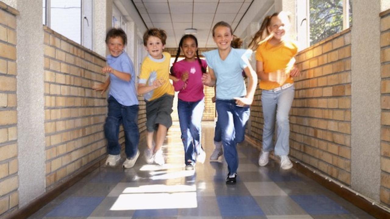 Children running in a hall.