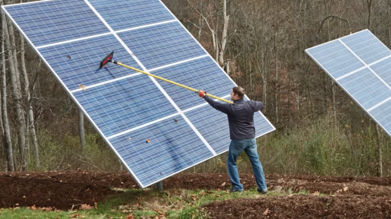 Chris Meyer cleans off the Solar panels at his home