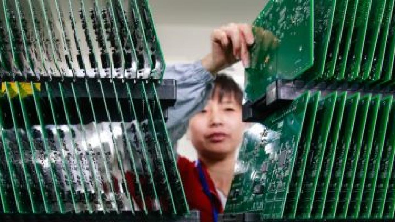 person sorting circuit boards