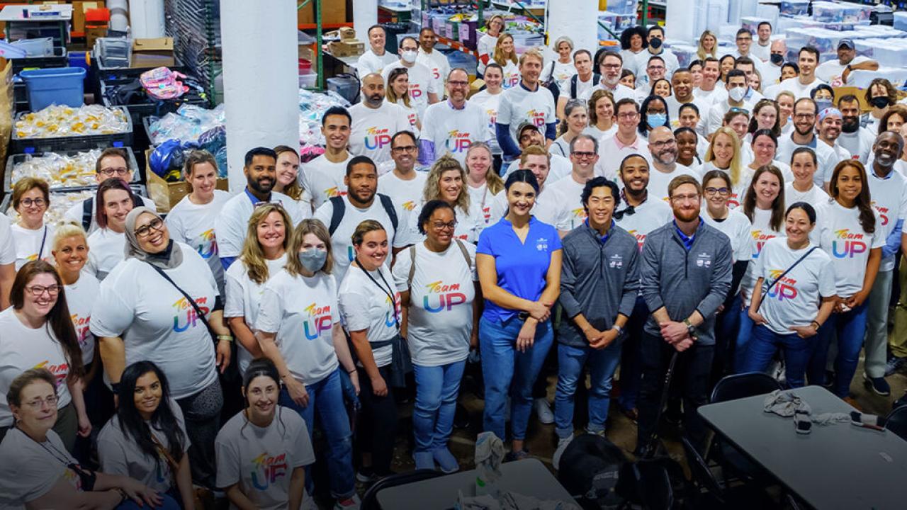 A large group of posed people, most in matching tshirts.