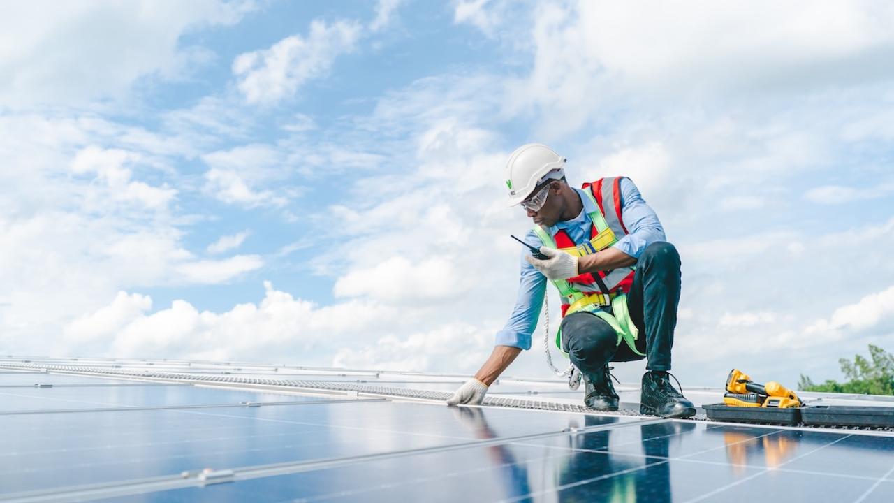 Wesco technician working on a solar panel array.
