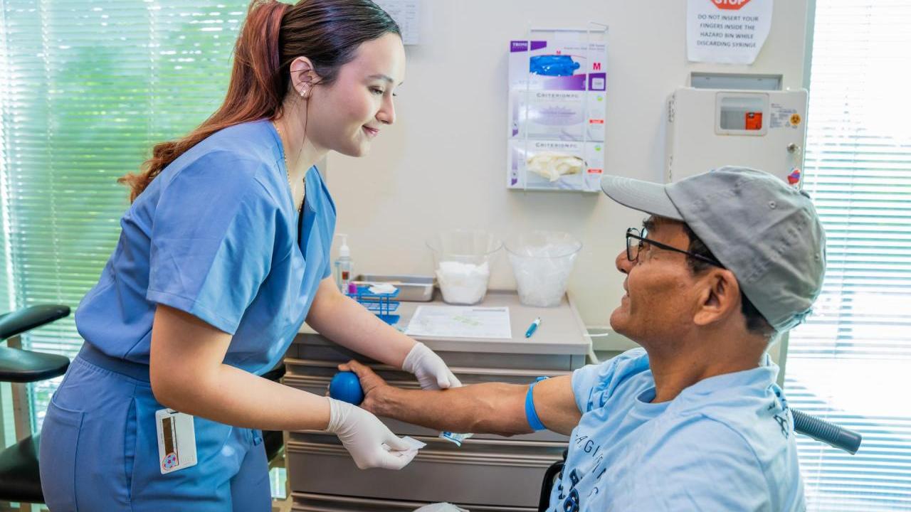 Lab Technician prepares to draw blood from a patient