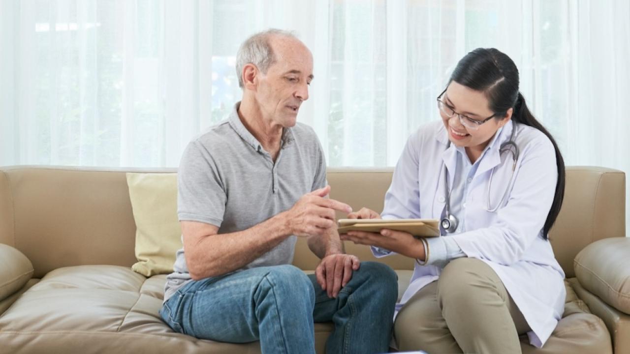 Female medical professional consulting with a male patient.