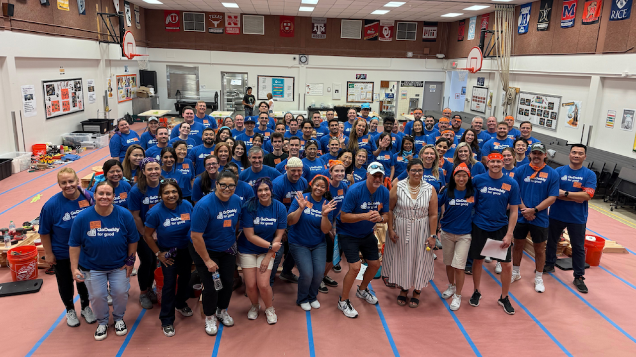 Group photo of GoDaddy volunteers in gym