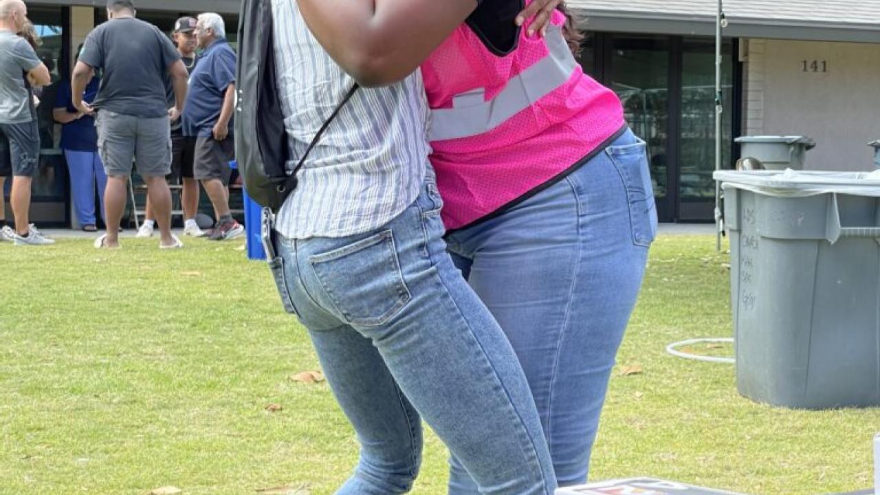 Community support, employee hugging a person in need