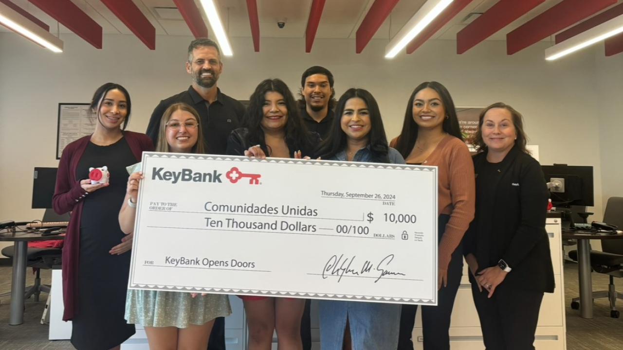 Team members from KeyBank and Salt Lake City's Comunidades Unidas shown with a $10,000 grant check.