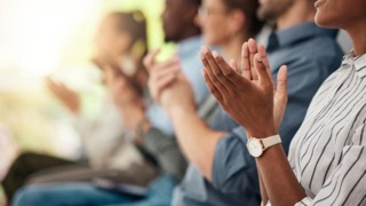 People clapping hands in support of speech or presentation