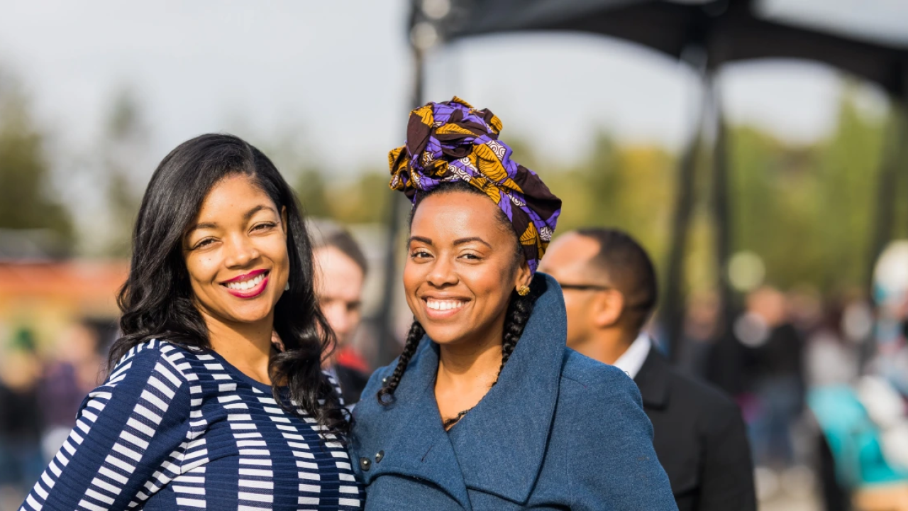 two smiling women in a crowd
