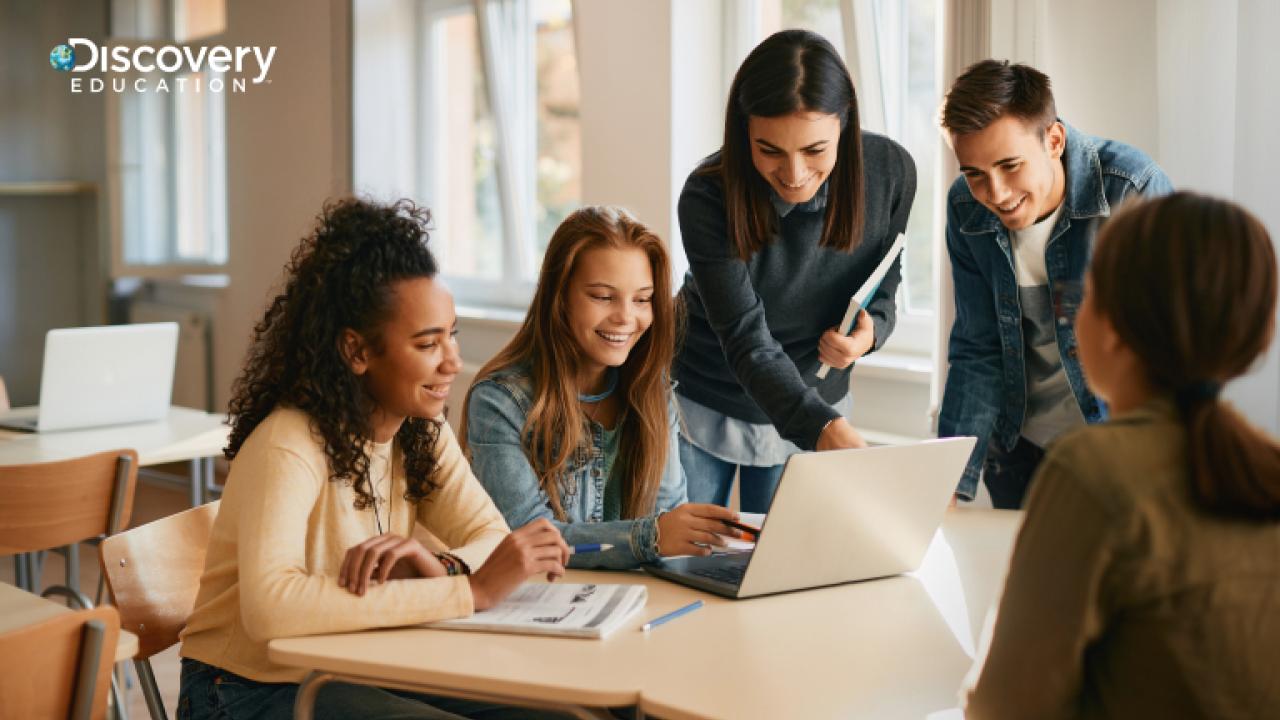 students looking at a laptop together
