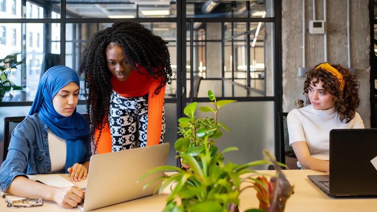 diverse women working on laptops